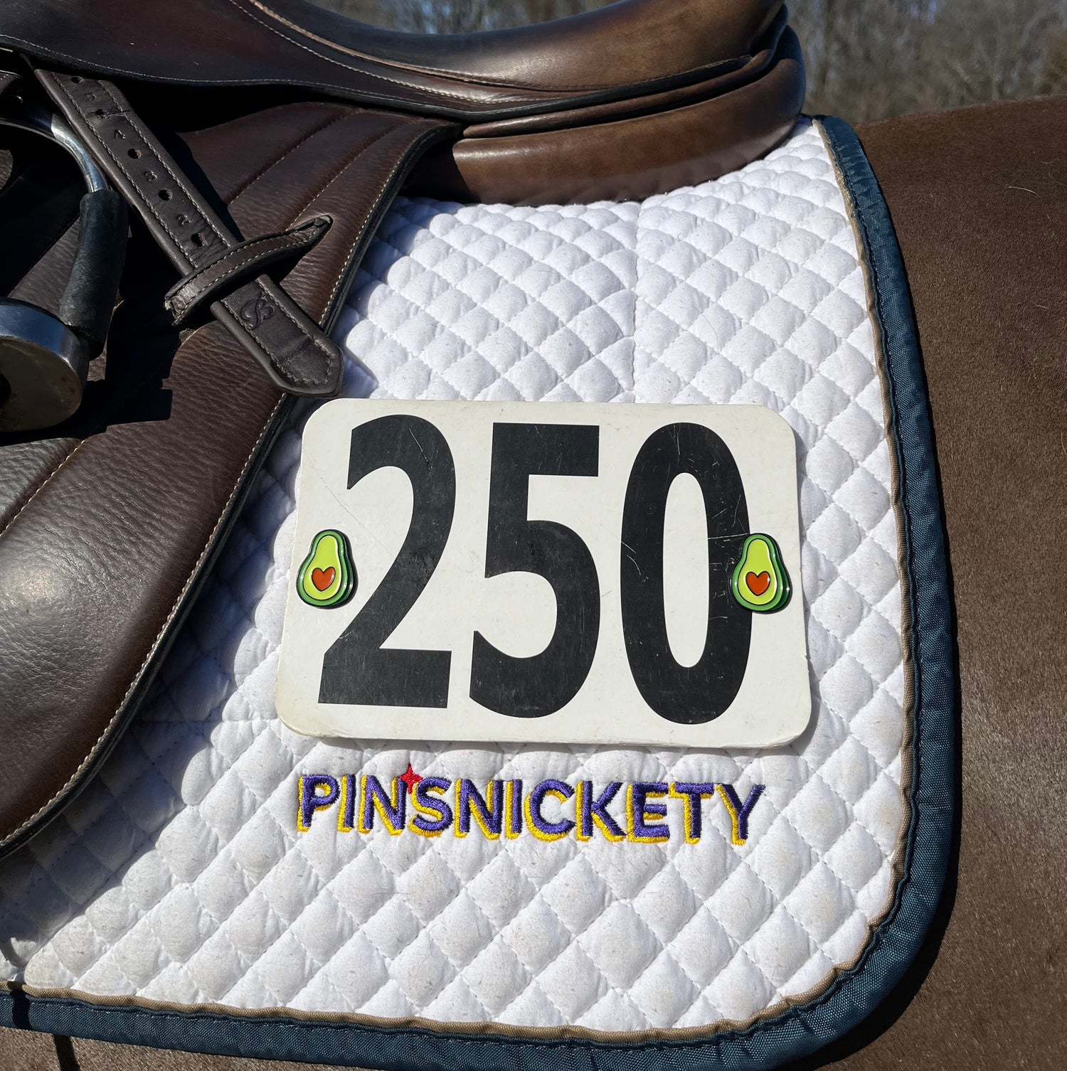pinsnickety avocado horse show number pins on a saddle pad