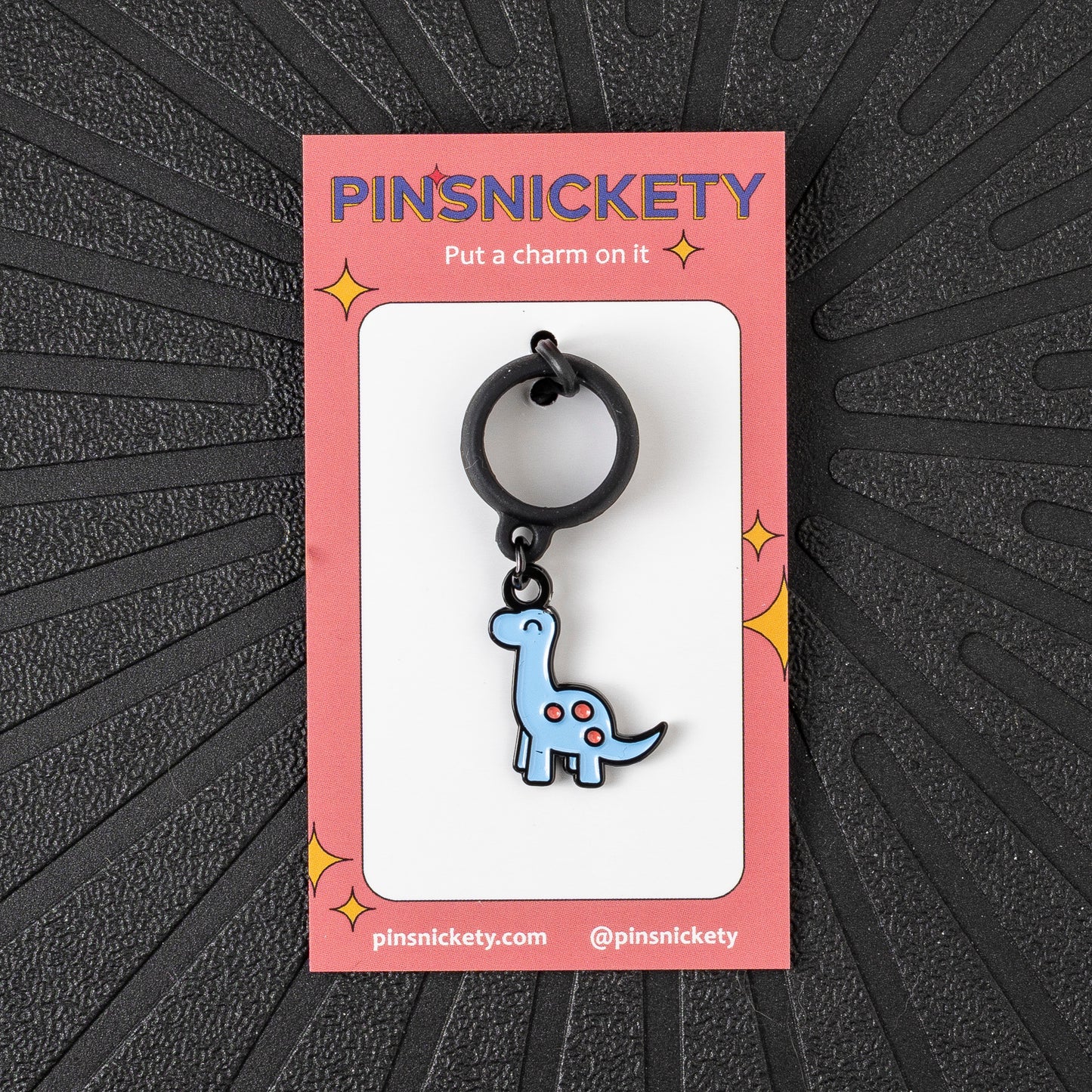 Pinsnickety Brontosaurus crop charm in front of a black background
