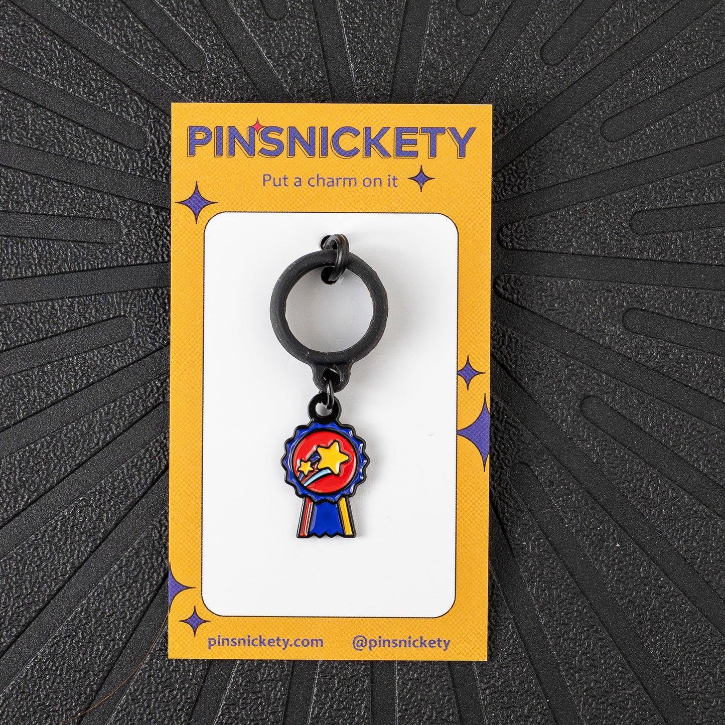 Pinsnickety champion crop charm in front of a black background