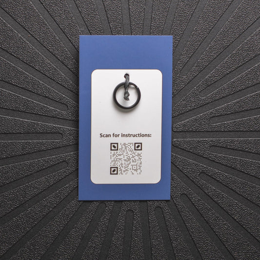 pinsnickety charm back, showing black split ring and qr code