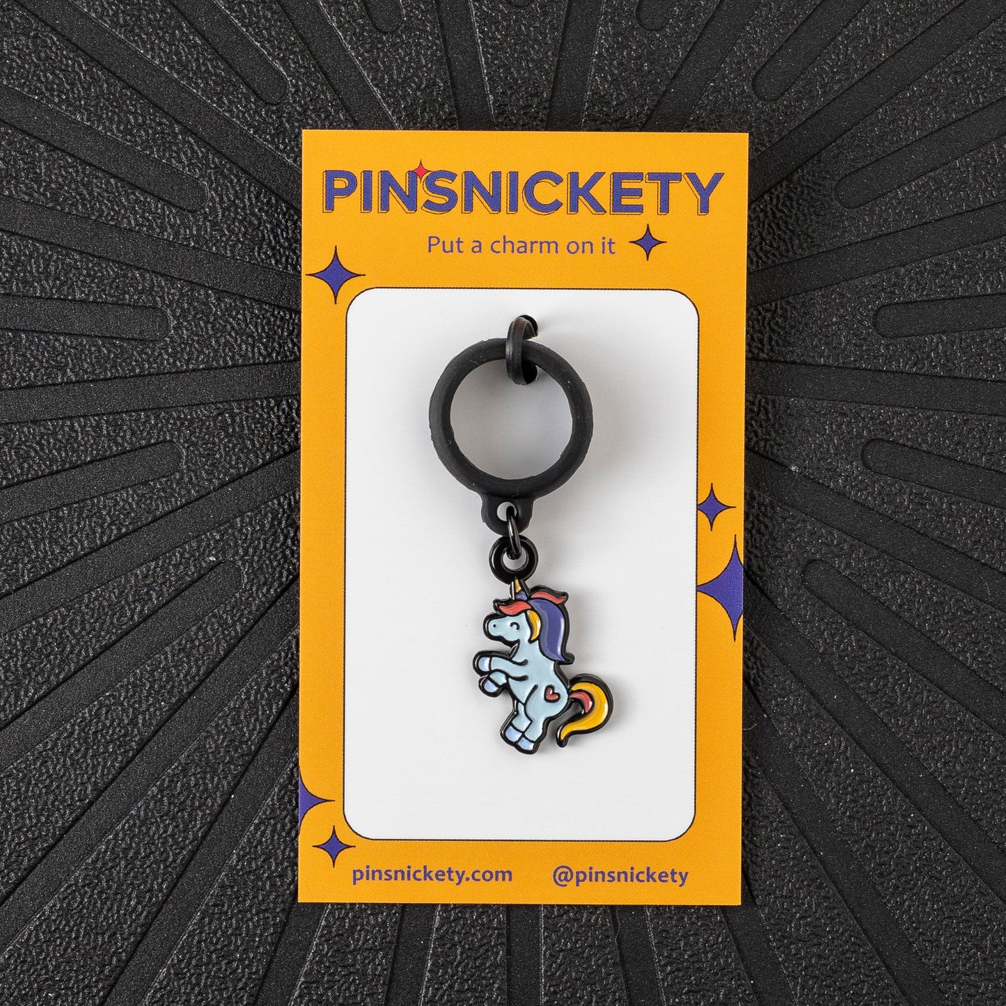 Pinsnickety Flying Unicorn crop charm in front of a black background