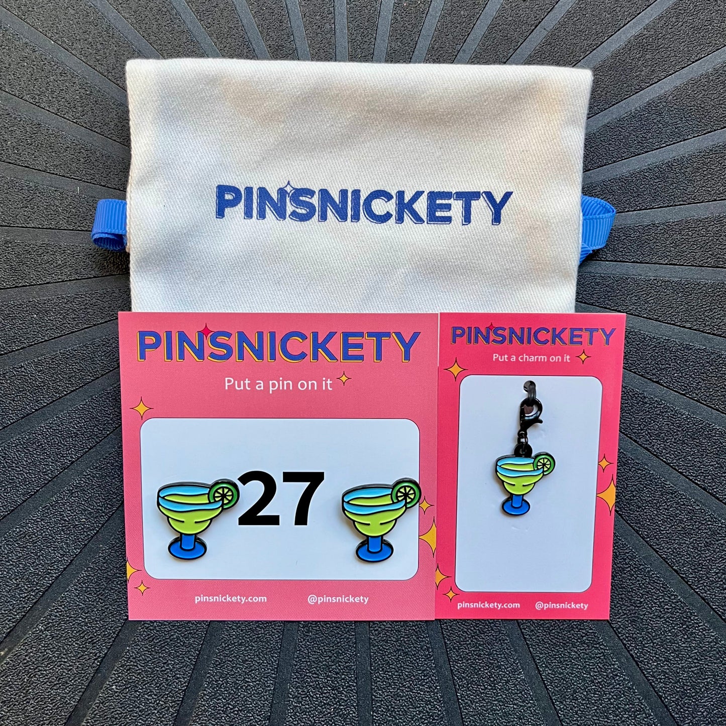 pinsnickety margarita matching set, including margarita horse show number pins, margarita bridle charm, and a twill storage bag, against a black background