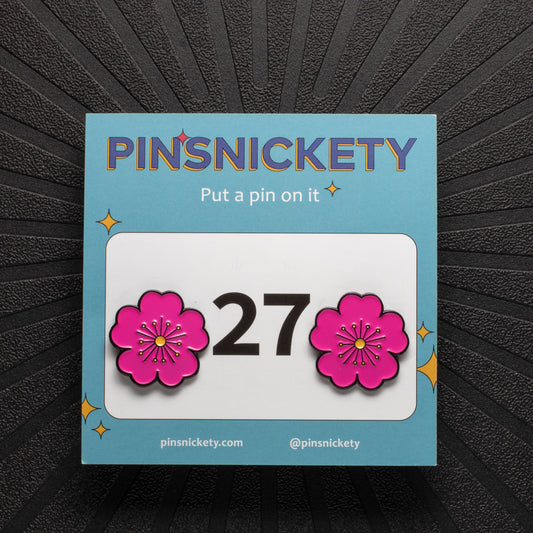 pinsnickety pink poppy horse show number pins on a black background