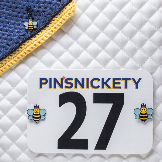 pinsnickety queen bee set with queen bee braid and bridle charm on a bonnet and queen bee horse show number pins on a saddle pad
