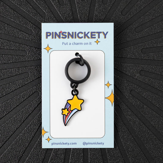 Pinsnickety Shooting Star crop charm in front of a black background