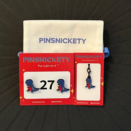 Pinsnickety matching set featuring T-rex horse show number pins, a t-rex braid and bridle charm, and a pinsnickety deluxe twill storage bag