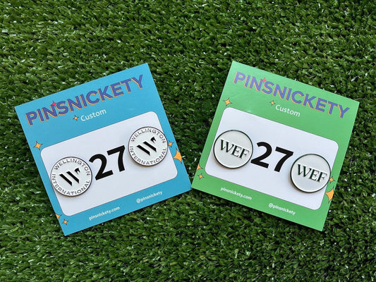 pinsnickety winter equestrian festival custom horse show number pins in two designs on a green fake grass background