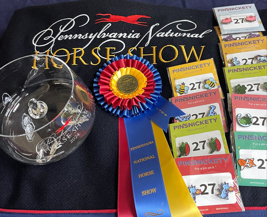 pinsnickety horse show number pins with a champion ribbon, trophy and cooler for the 1.15 junior jumper classic at the Pennsylvania National Horse Show