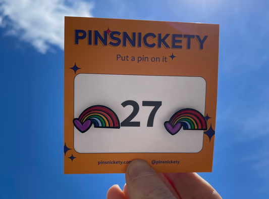 Pinsnickety Rainbow horse show number pins against a blue sky