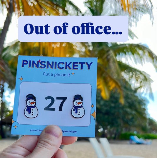 Pinsnickety snowman horse show number pins in front of a lounge chair on the beach with the words "out of office" typed on top