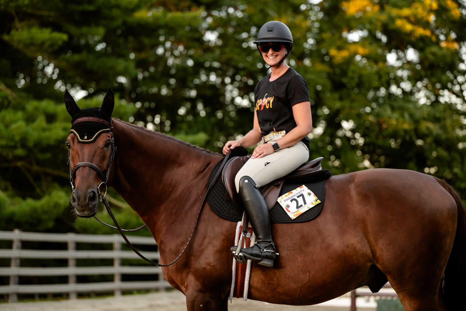 A horse and rider dressed up for some spice with pinsnickety chili pepper horse show number pins and bonnet charm