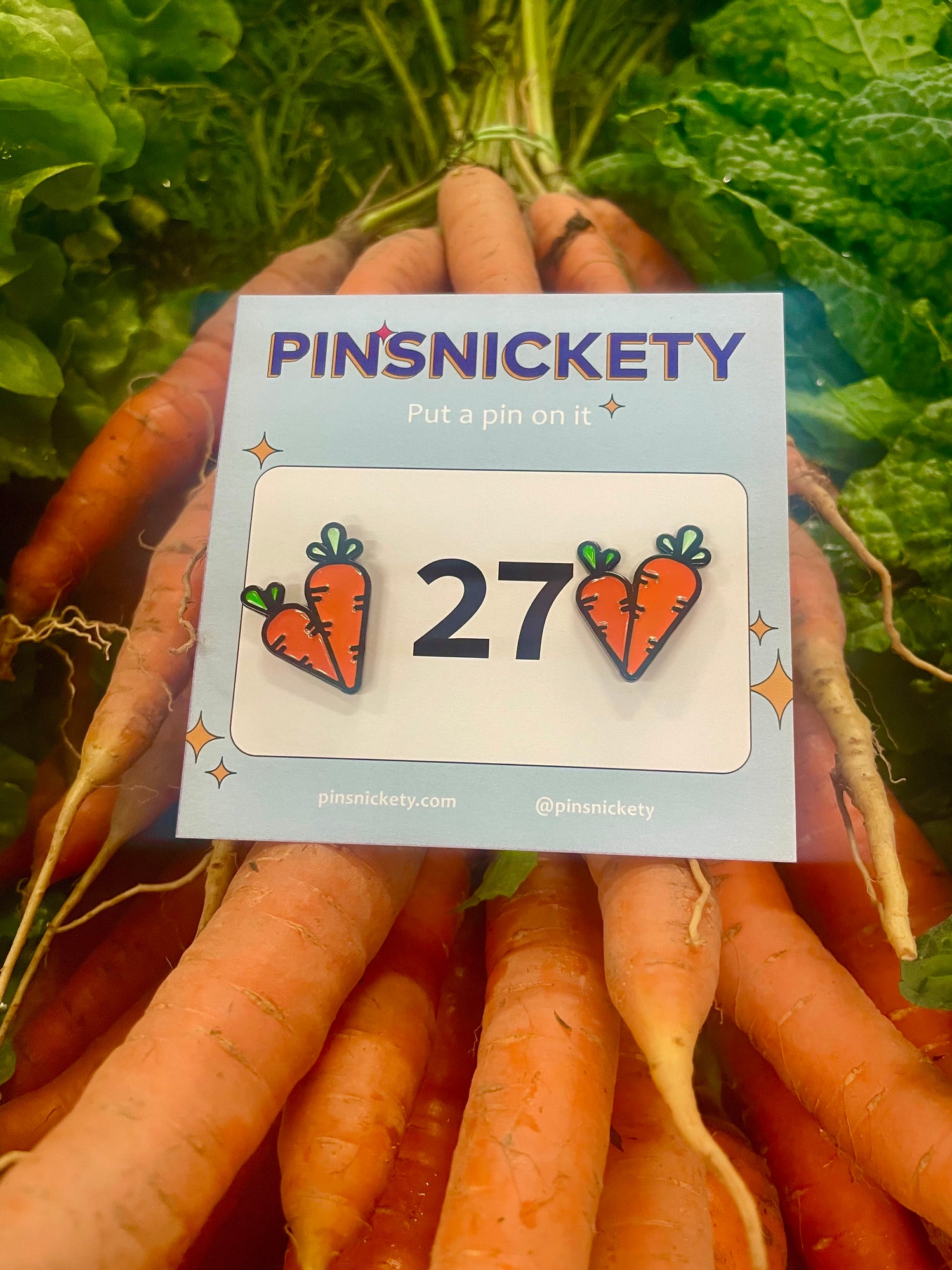 pinsnickeety carrots horse show number pins on top of a bunch of carrots in a farmer's market