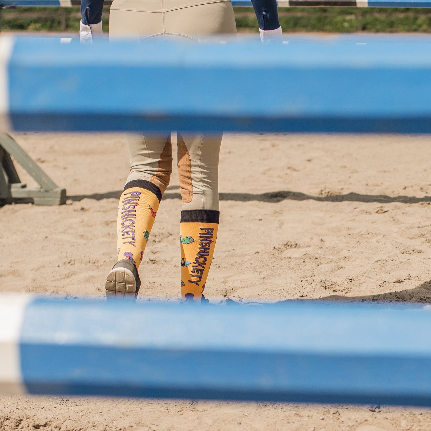 pinsnickety yellow tall boot socks on a rider walking her jumper course