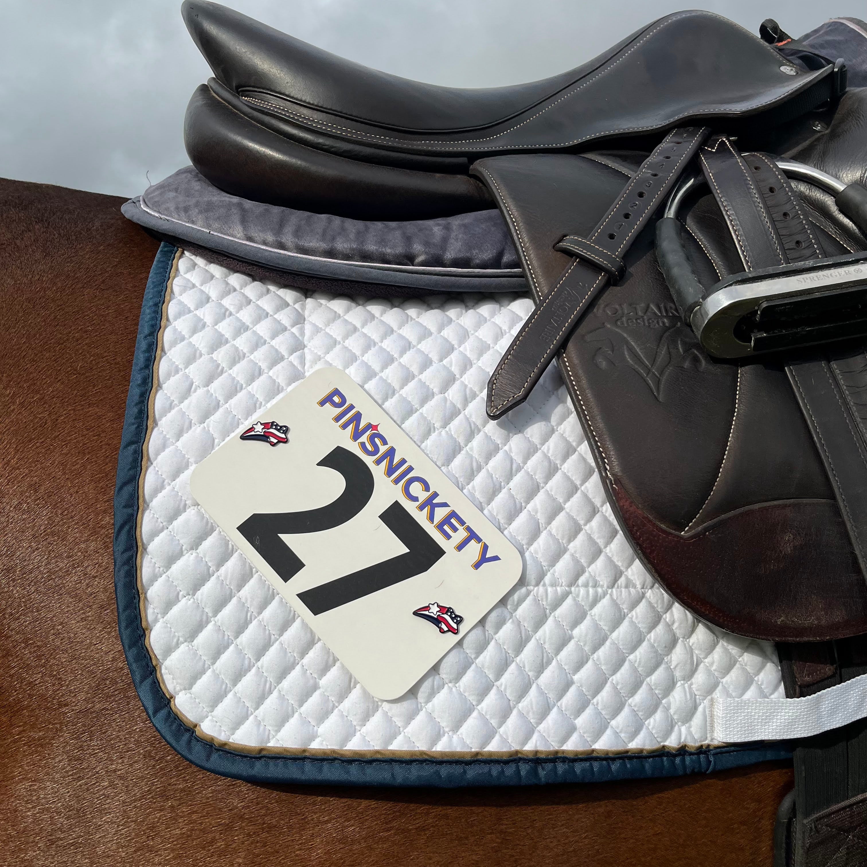 pinsnickety stars and stripes horse show number pins on a saddle pad
