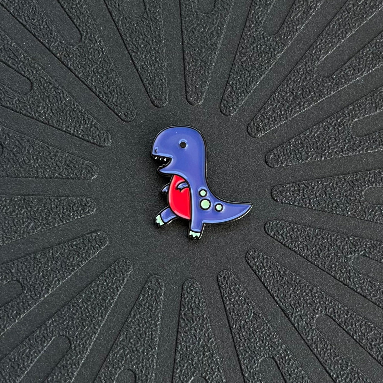 pinsnickety t-rex horse show number pin alone on a black background