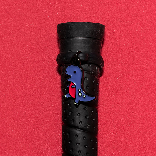 Pinsnickety T-Rex crop charm on a whip handle in front of a colored background