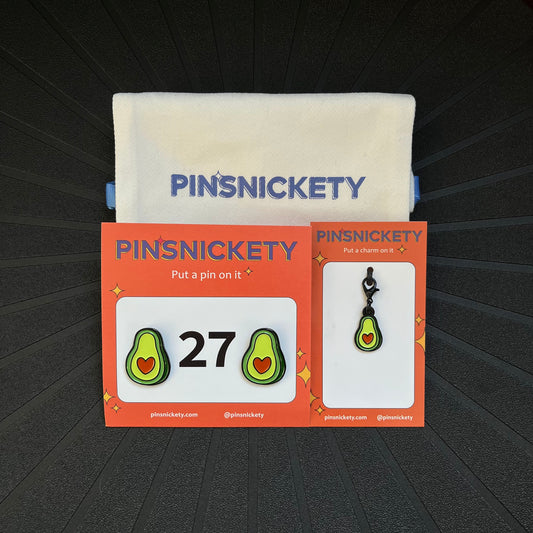 pinsnickety avocado bundle, featuring avocado horse show number pins, an avocado bridle charm, and a pinsnickety twill storage bag, on a black background