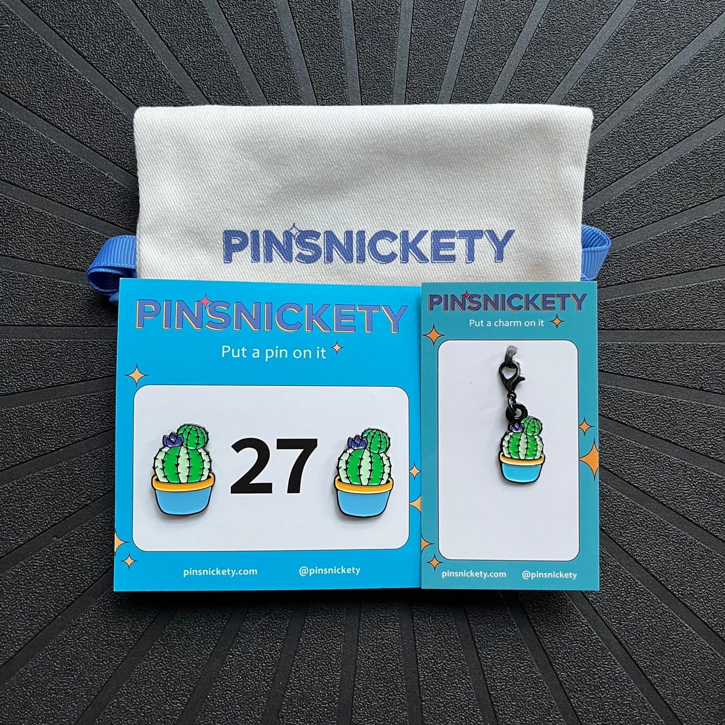 pinsnickety cactus matching set, featuring a pair of cactus horse show number pins, a cactus bridle charm, and a deluxe twill bag, all displayed on a black background