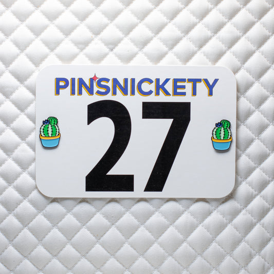 Pinsnickety cactus horse show number pin on a saddle pad