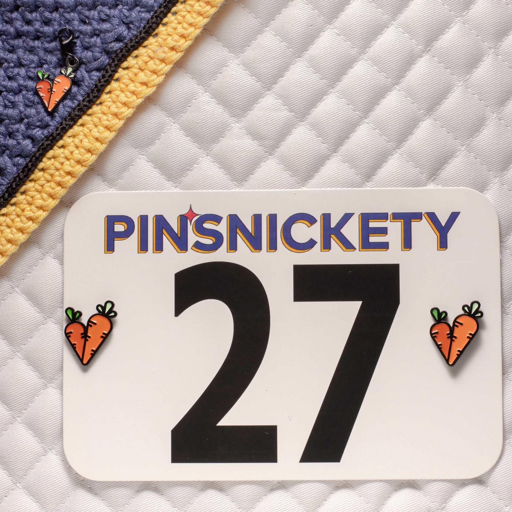 pinsnickety carrots matching set, with a carrots bridle charm on a bonnet and carrots horse show number pins on a saddle pad