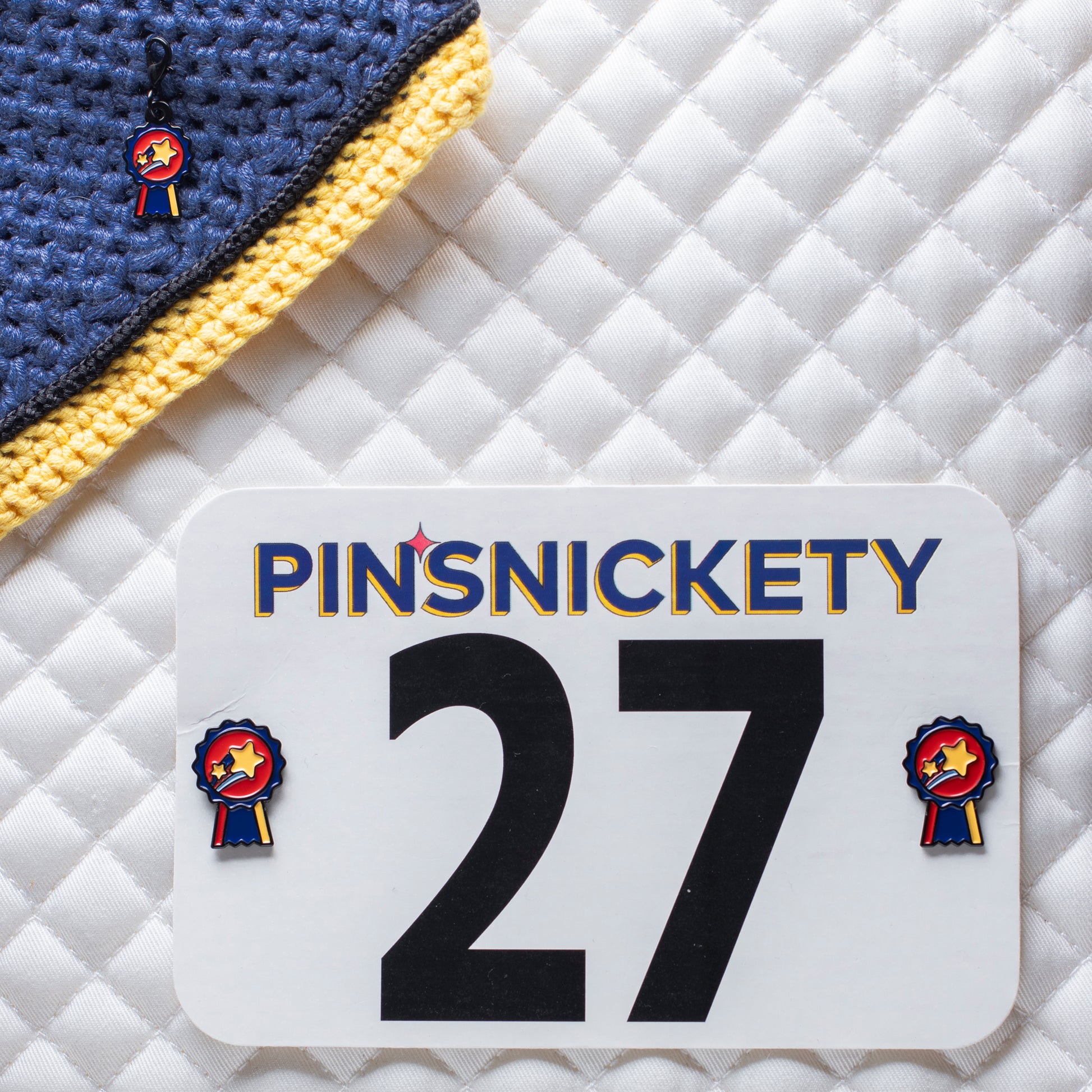 pinsnickety champion braid and bridle charm on a bonnet and champion horse show number pins on a saddle pad