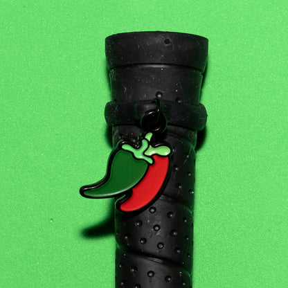 Pinsnickety Chili Peppers crop charm on a whip handle in front of a colored background