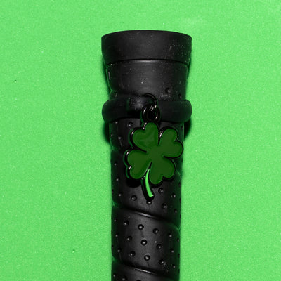 Pinsnickety Clover crop charm on a whip handle in front of a colored background