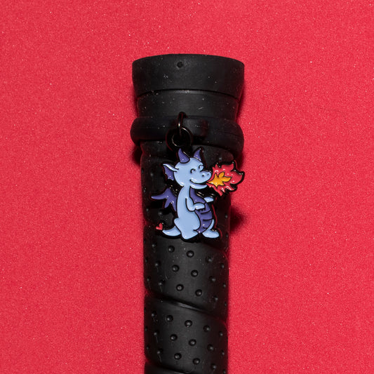 Pinsnickety Dragon crop charm on a whip handle in front of a colored background