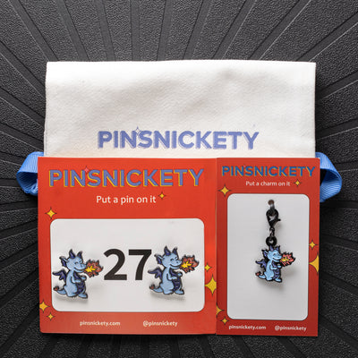 pinsnickety dragon set with horse show number pins, a braid and bridle charm, and a twill storage bag on a black background