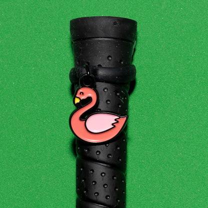 Pinsnickety Flamingo crop charm on a whip handle in front of a colored background