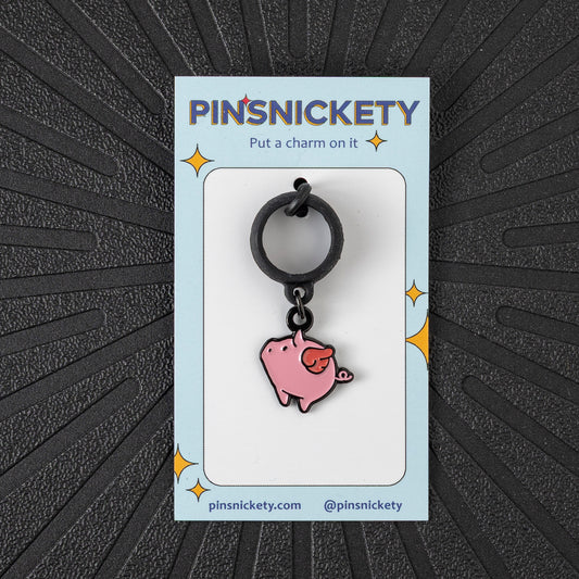 Pinsnickety Flying Pig crop charm in front of a black background