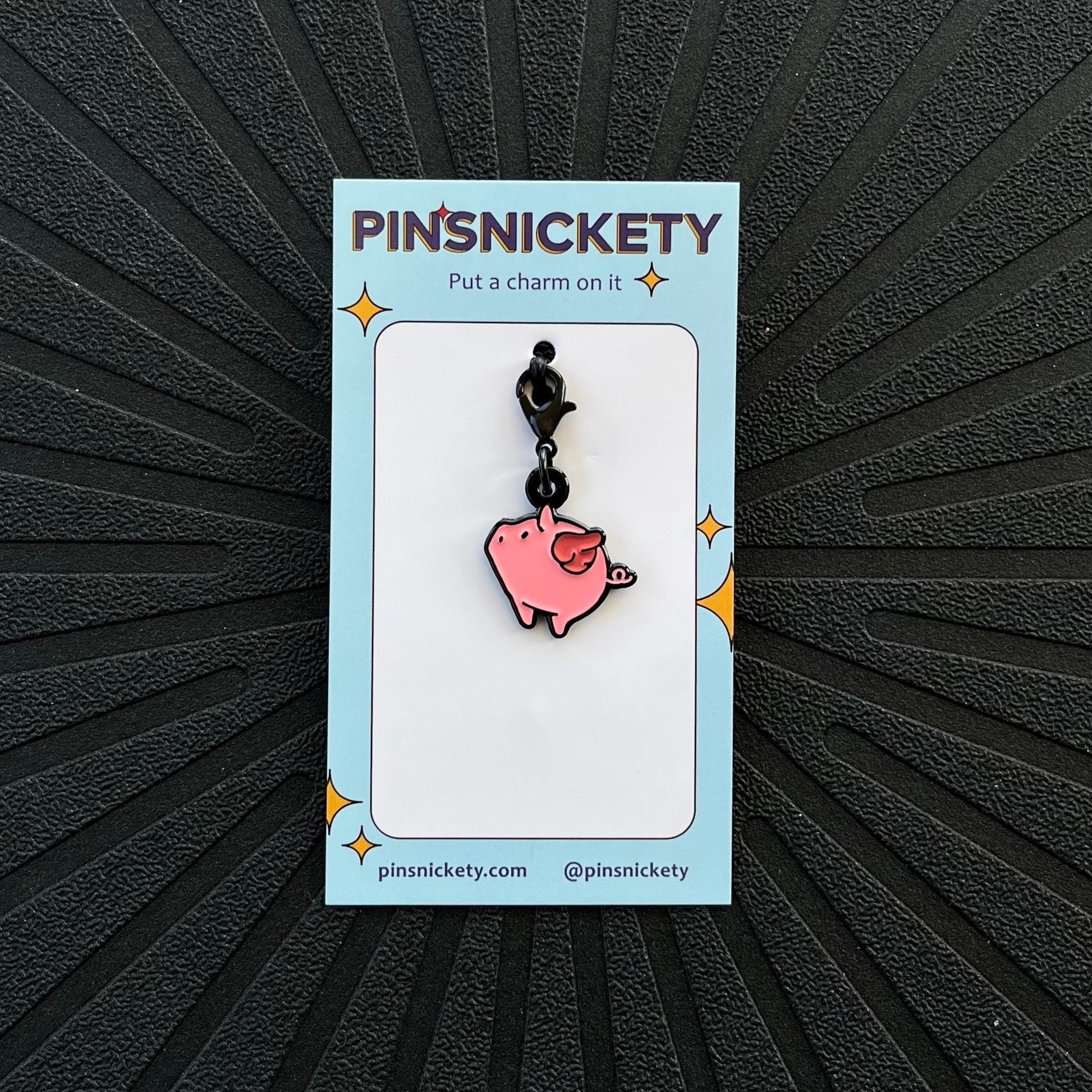 pinsnickety flying pig braid bridle and bonnet charm on a black background