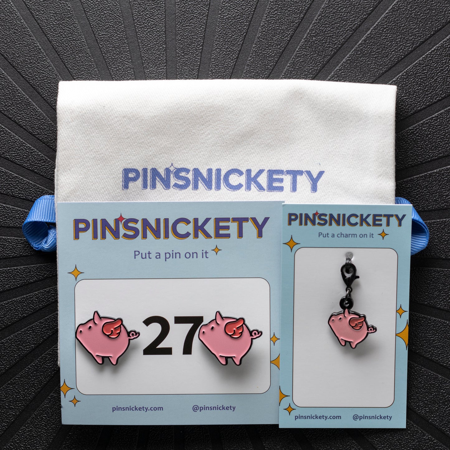 pinsnickety flying pig set, with flying pig horse show number pins, a flying pig braid and bridle charm, and a twill storage bag
