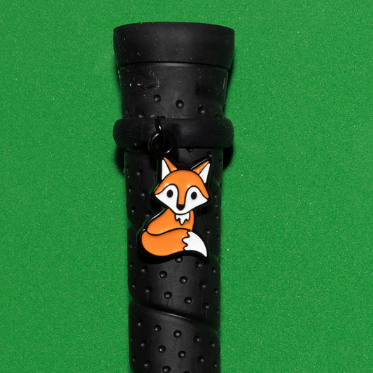 Pinsnickety Fox crop charm on a whip handle in front of a colored background