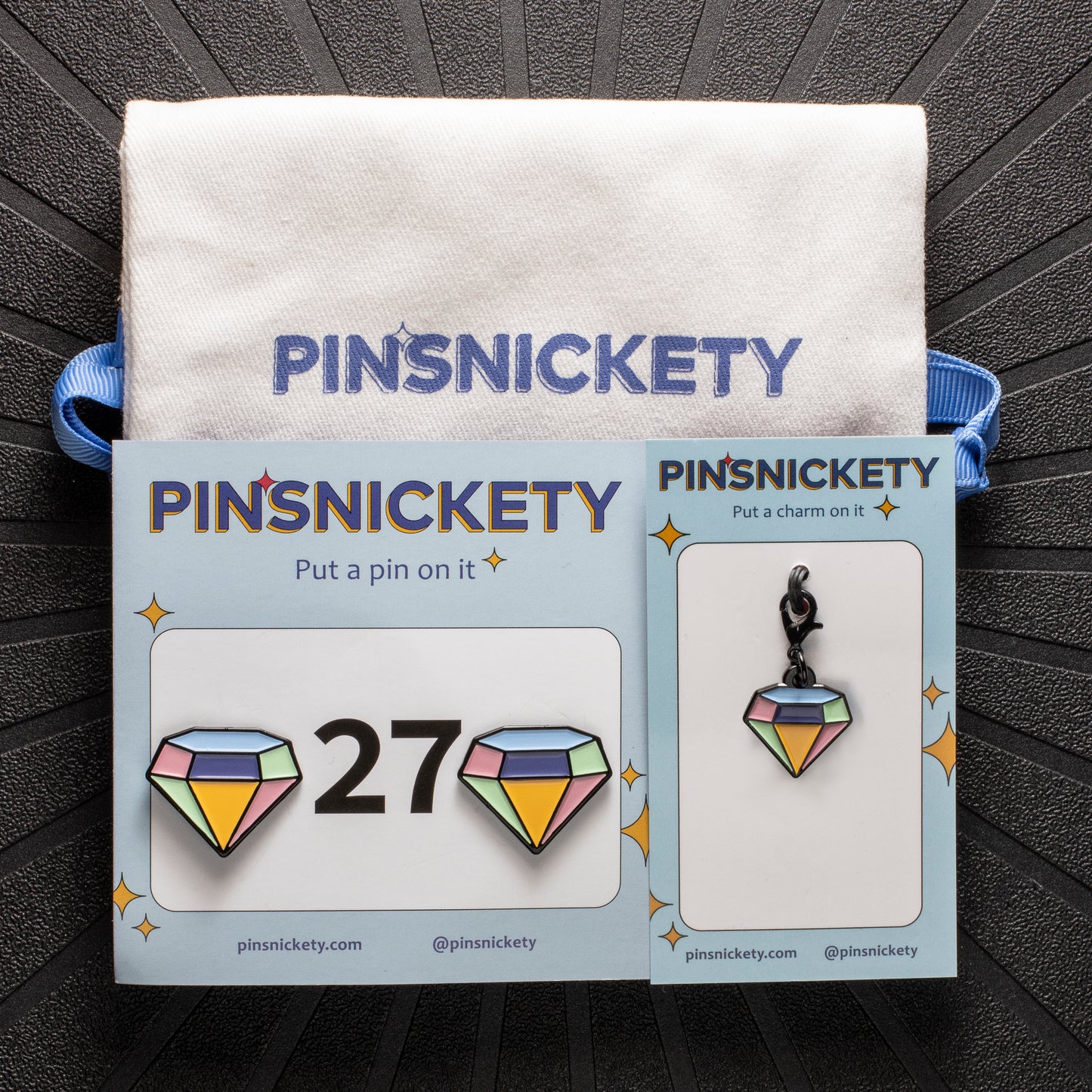 pinsnickety gem set, featuring gem horse show number pins, a gem bridle charm, and a pinsnickety twill storage bag