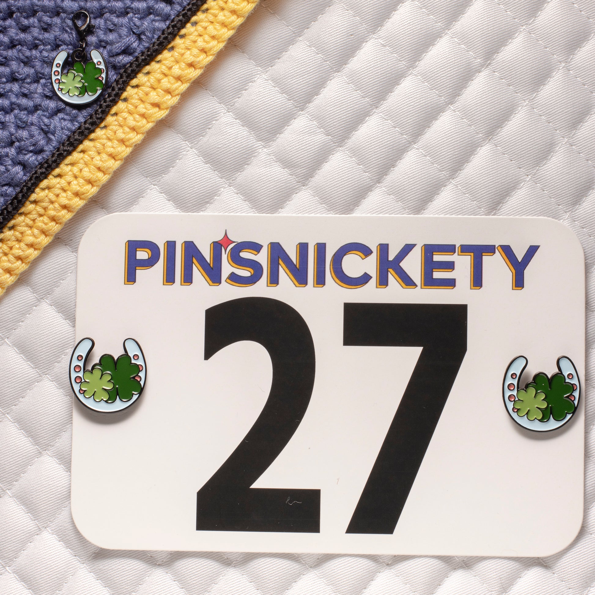 Pinsnickety horseshoe horse show number pins on a saddle pad and horseshoe braid and bridle charm on a bonnet