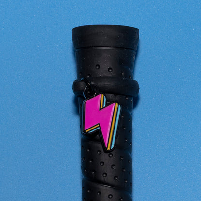 Pinsnickety Lightning Bolt crop charm on a whip handle in front of a colored background