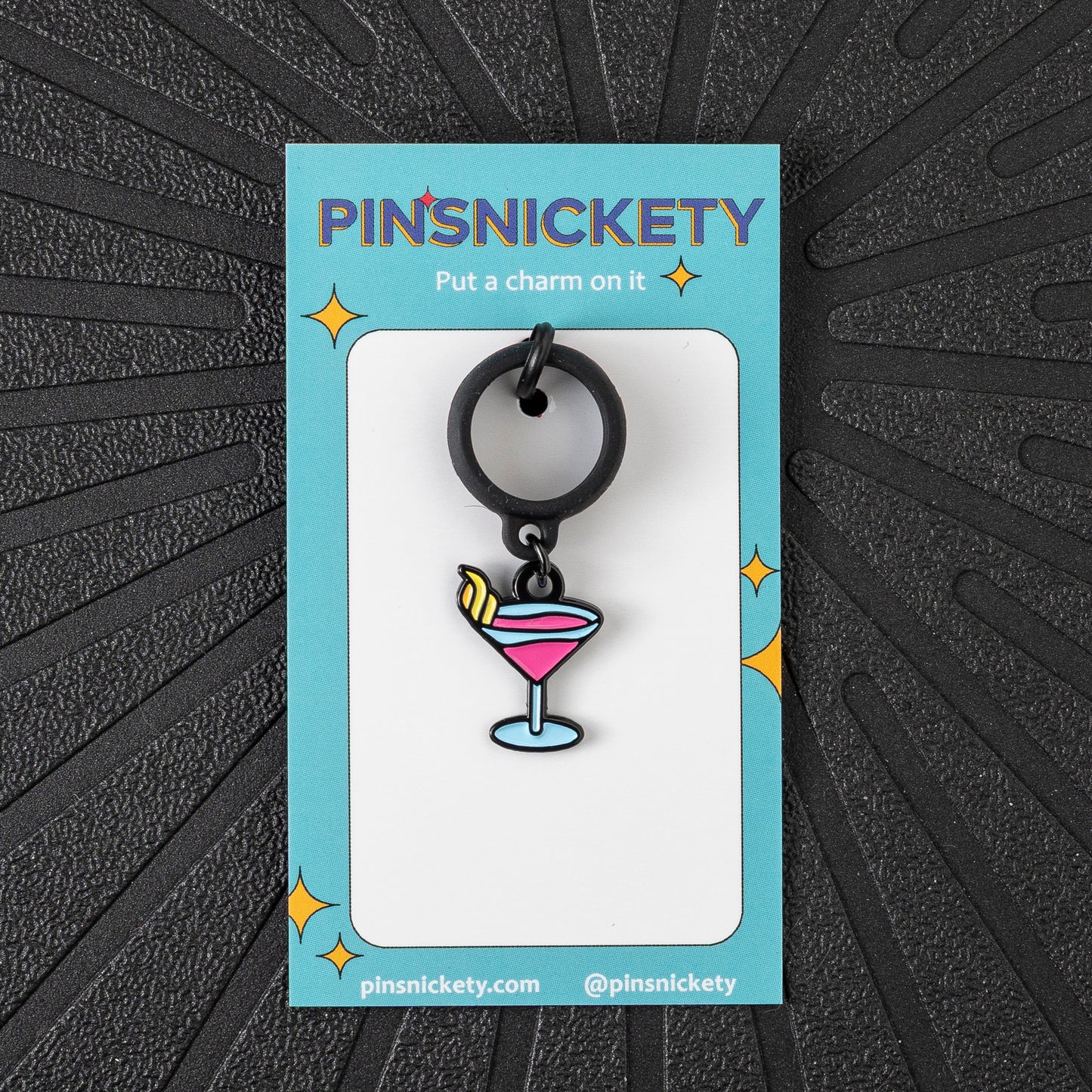 Pinsnickety Martini crop charm in front of a black background