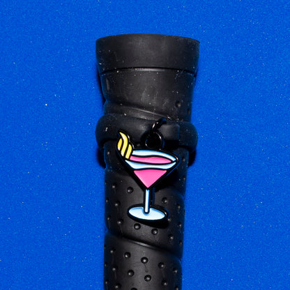 Pinsnickety Martini crop charm on a whip handle in front of a colored background