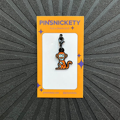pinsnickety monkey bridle charm on a black background
