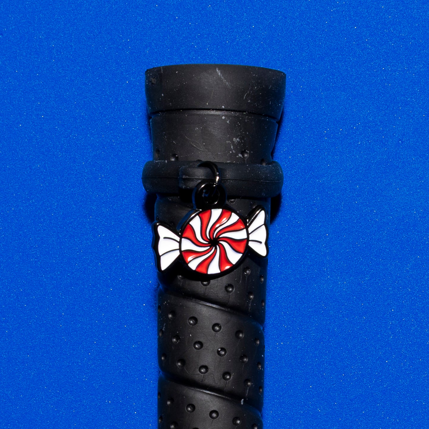 Pinsnickety Peppermint crop charm on a whip handle in front of a colored background