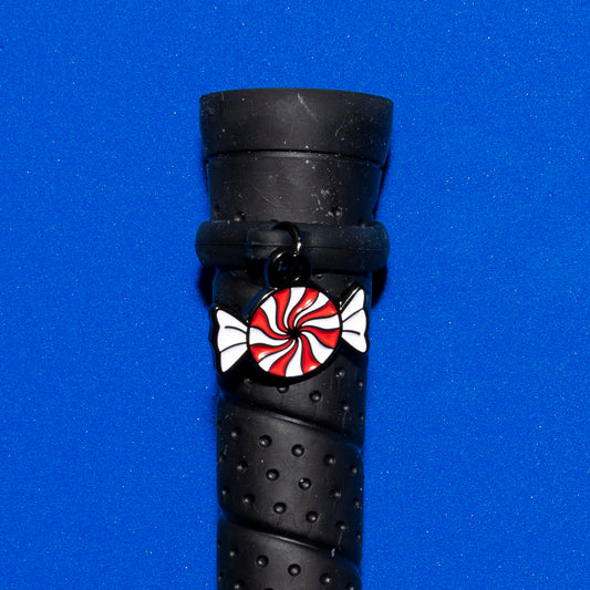 Pinsnickety Peppermint crop charm on a whip handle in front of a colored background