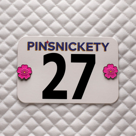 pinsnickety pink poppy horse show number pins on a saddle pad