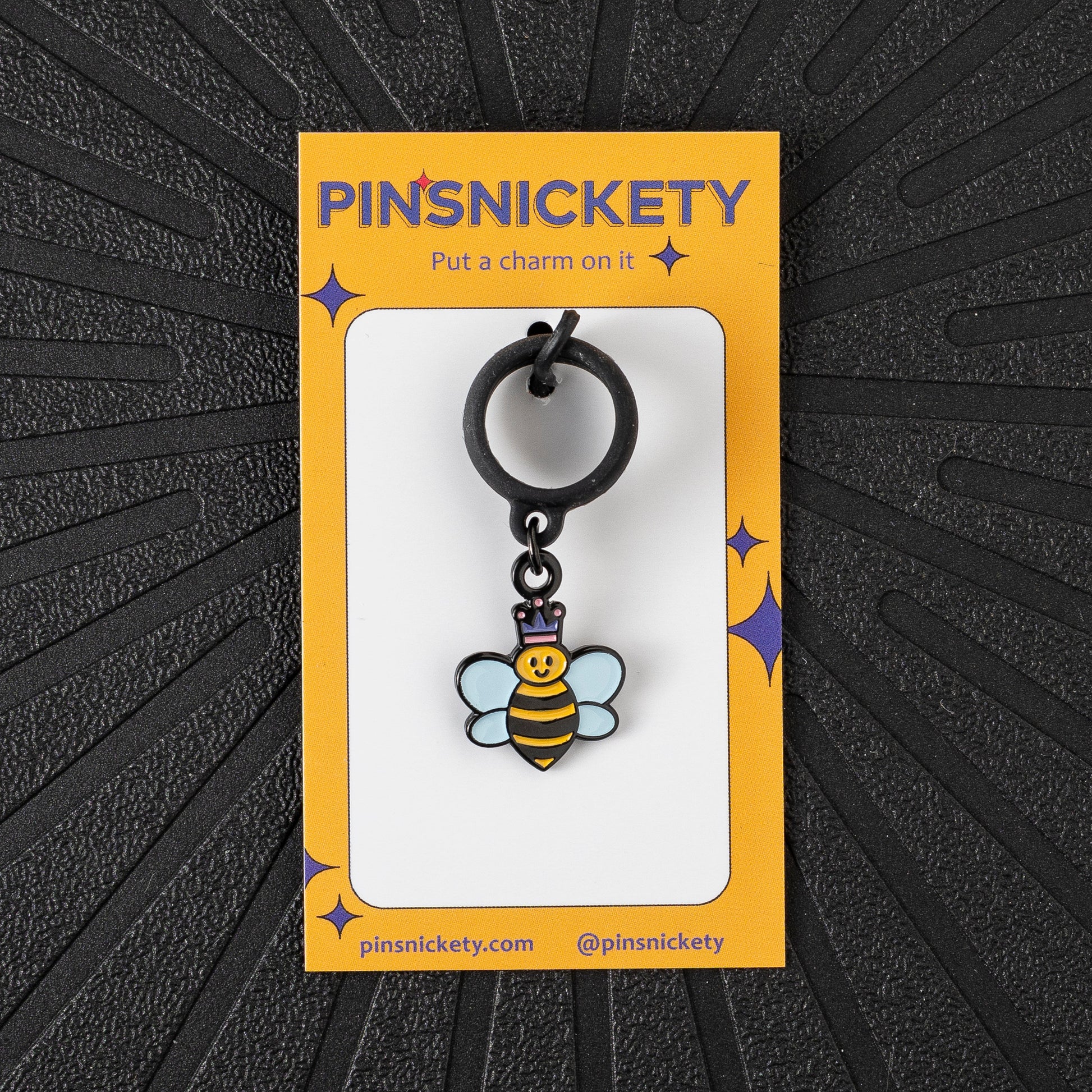 Pinsnickety Queen Bee crop charm in front of a black background