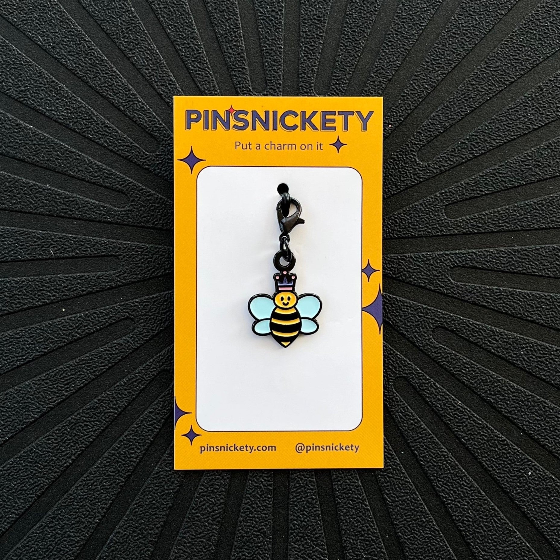 pinsnickety queen bee braid brildle and bonnet charm on a black background