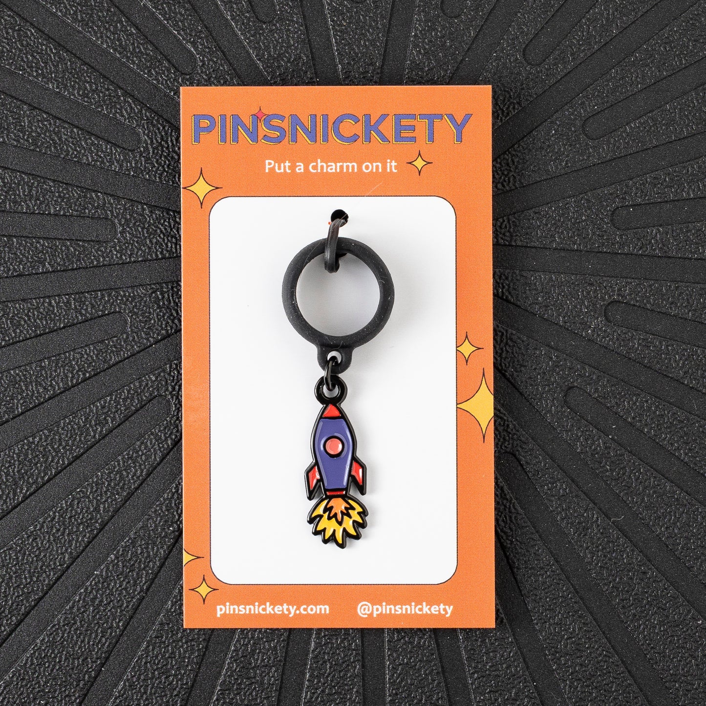 Pinsnickety Rocket Ship crop charm in front of a black background