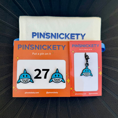 pinsnickety shark horse show number pins and a matching bridle charm on a black background with a deluxe twill storage bag