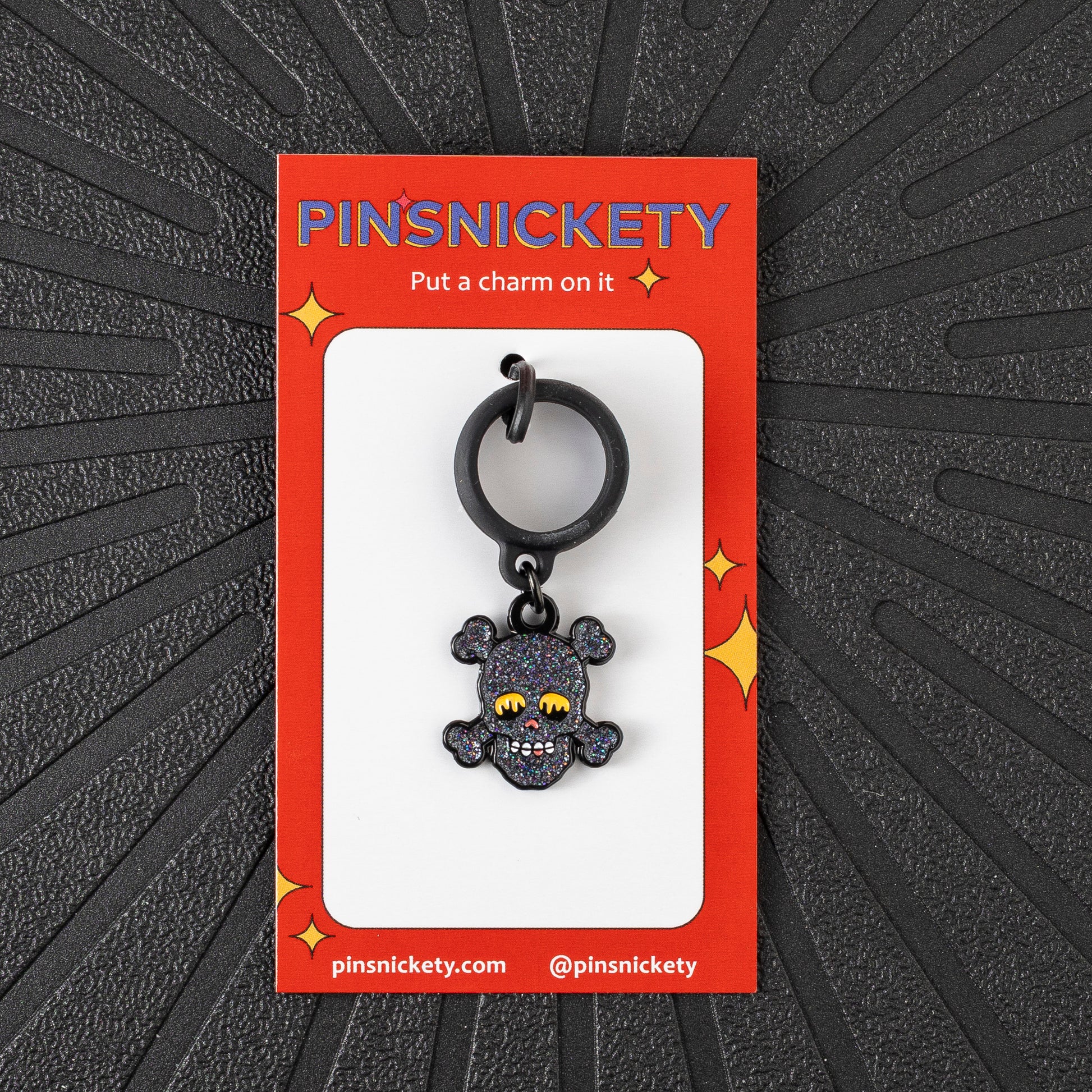 Pinsnickety Skull crop charm in front of a black background