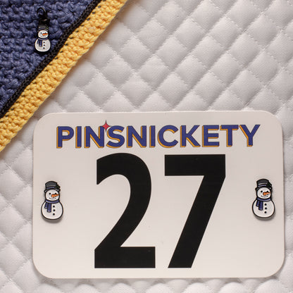pinsnickety snowman set, featuring a snowman horse show number pins on a saddle pad and a snowman bridle charm on a bonnet