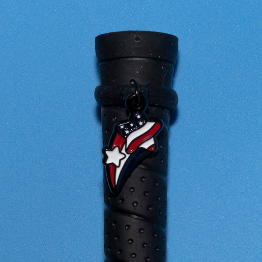 Pinsnickety Stars and stripes crop charm on a whip handle in front of a colored background